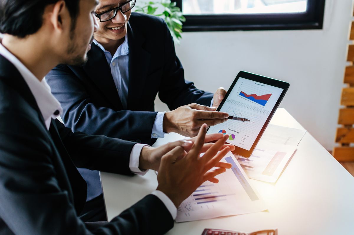 Finance executives reviewing data analytics and business performance